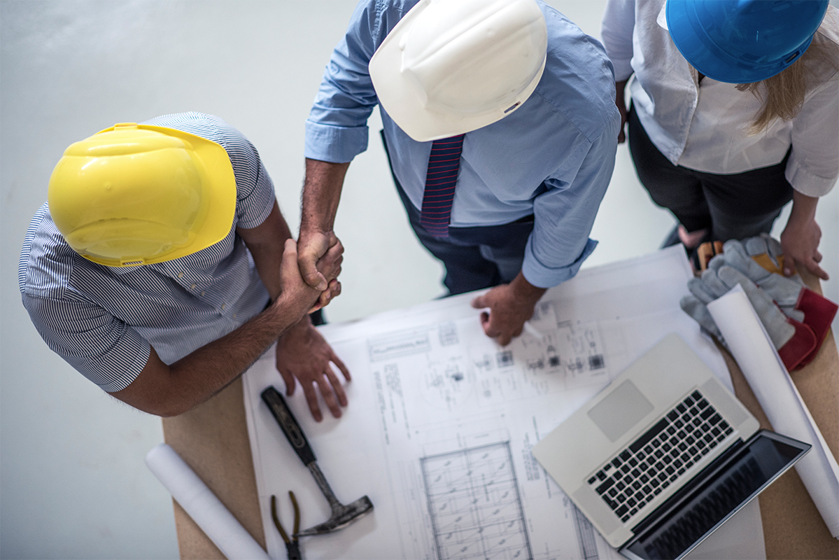 Aerial view of men in hardhats shaking hands